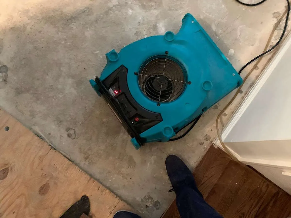 Air mover drying subfloor during Commercial Water Damage Restoration in Carolina Shores